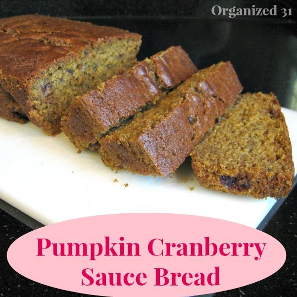 sliced bread loaf on a white platter with title text reading Pumpkin Cranberry Sauce Bread